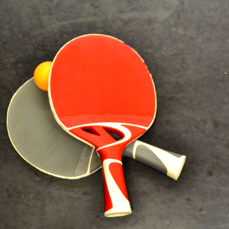 Table tennis paddles on the table.